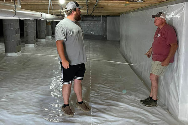 Workers in newly encapsulated crawl spaces